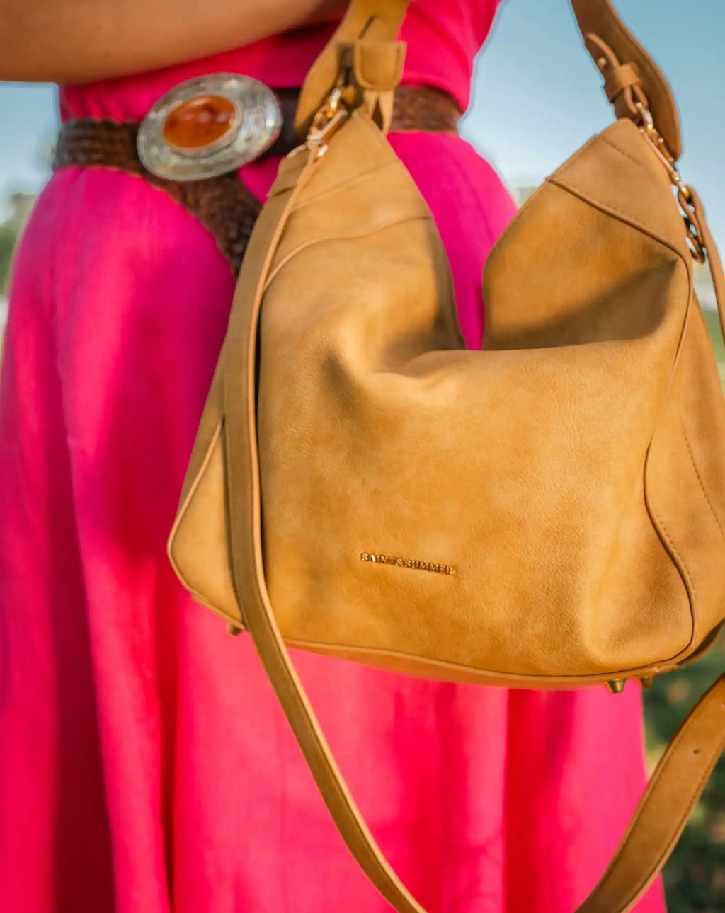 Tan leather hobo bag with a shoulder strap.